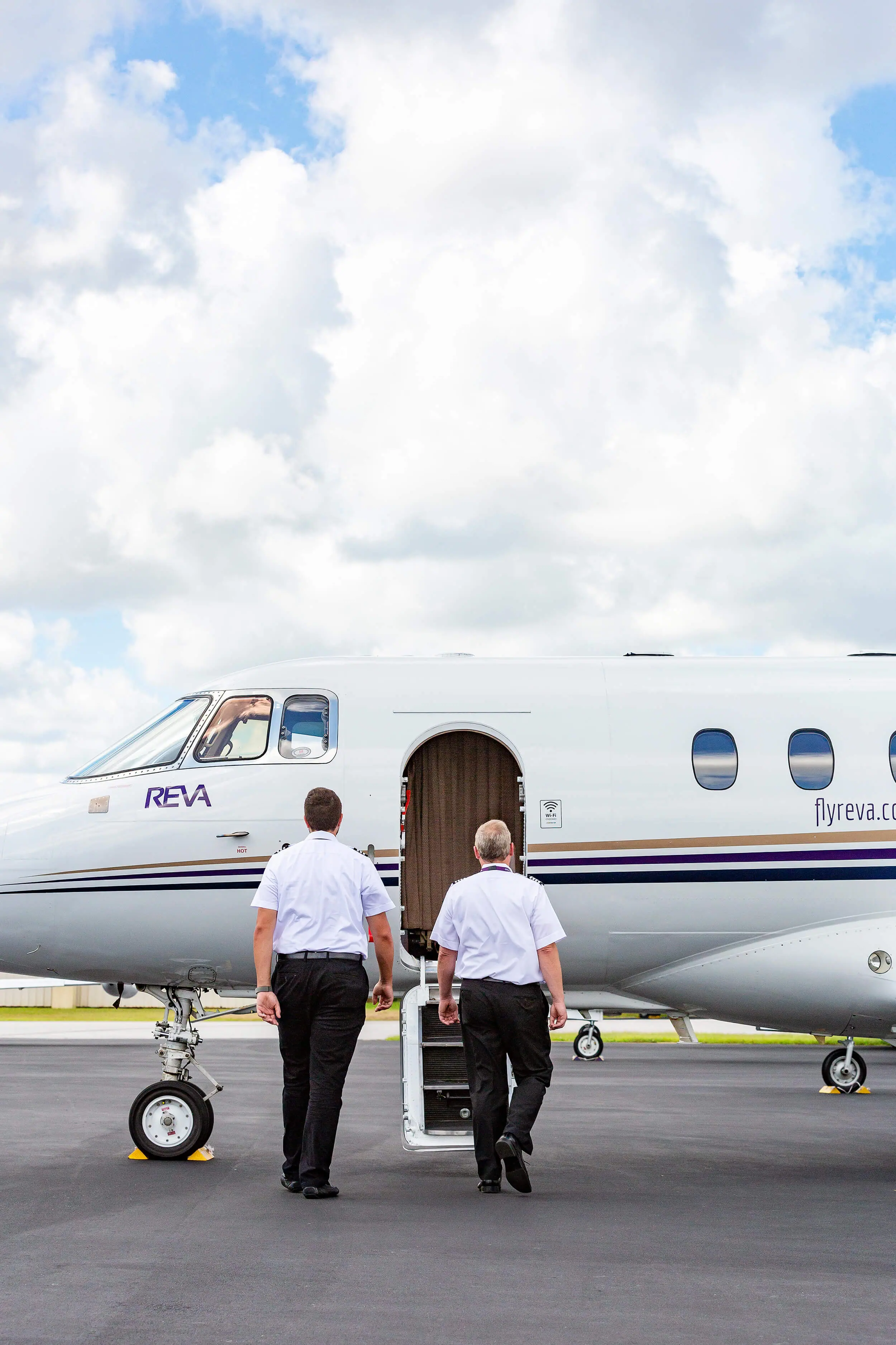 Pilots walking towards steps of an international air ambulance plane